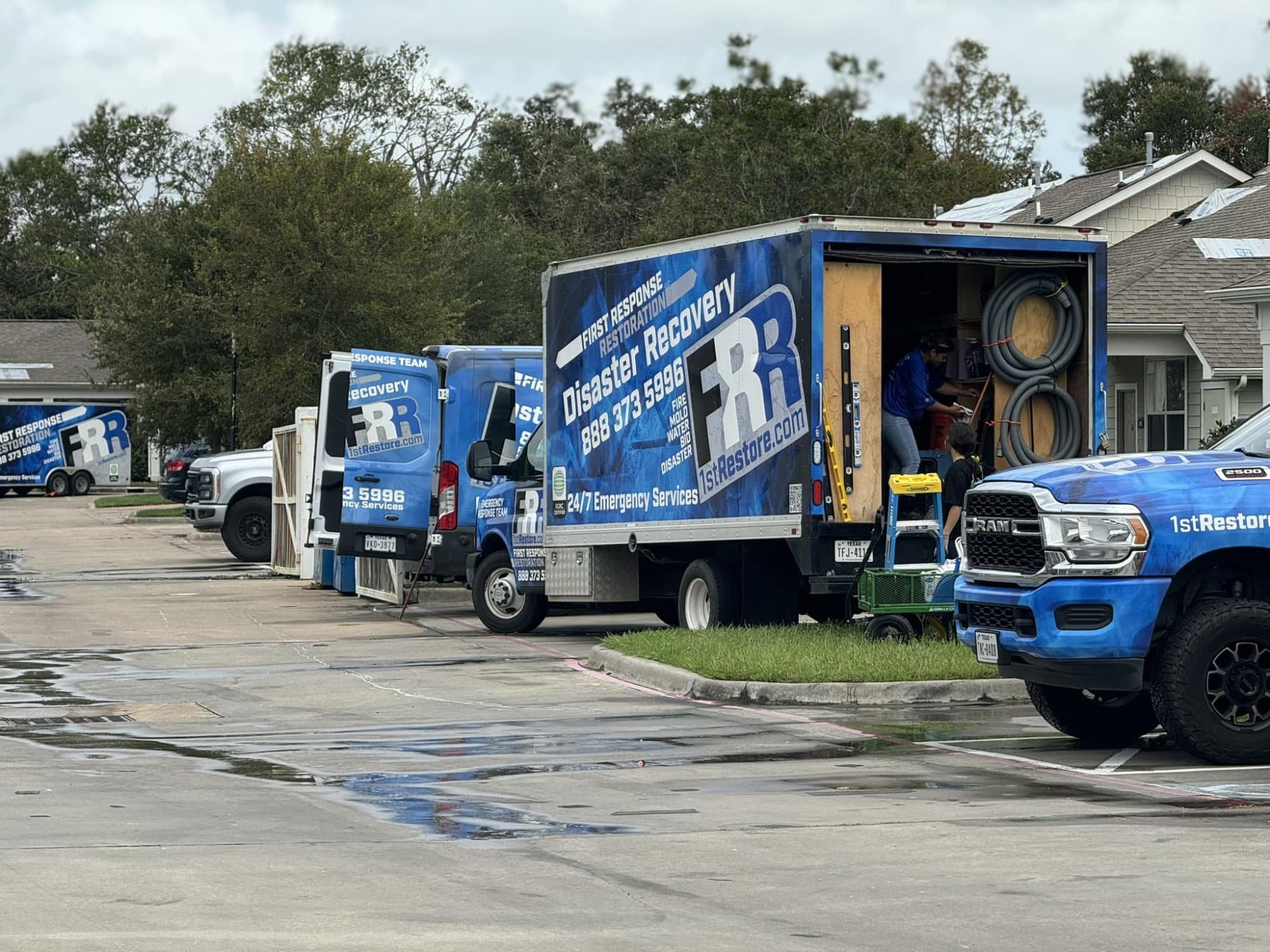 First Response Restoration fleet — multiple branded trucks ready to deploy in Houston TX