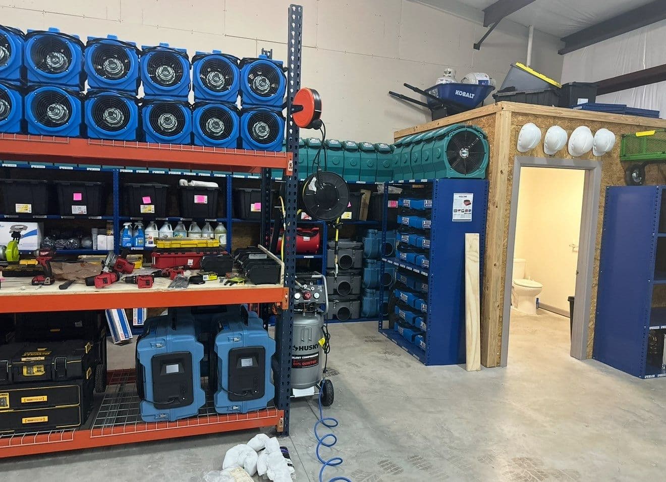 Fire damage restoration equipment staged at First Response Restoration warehouse — air scrubbers, ozone generators, HEPA units