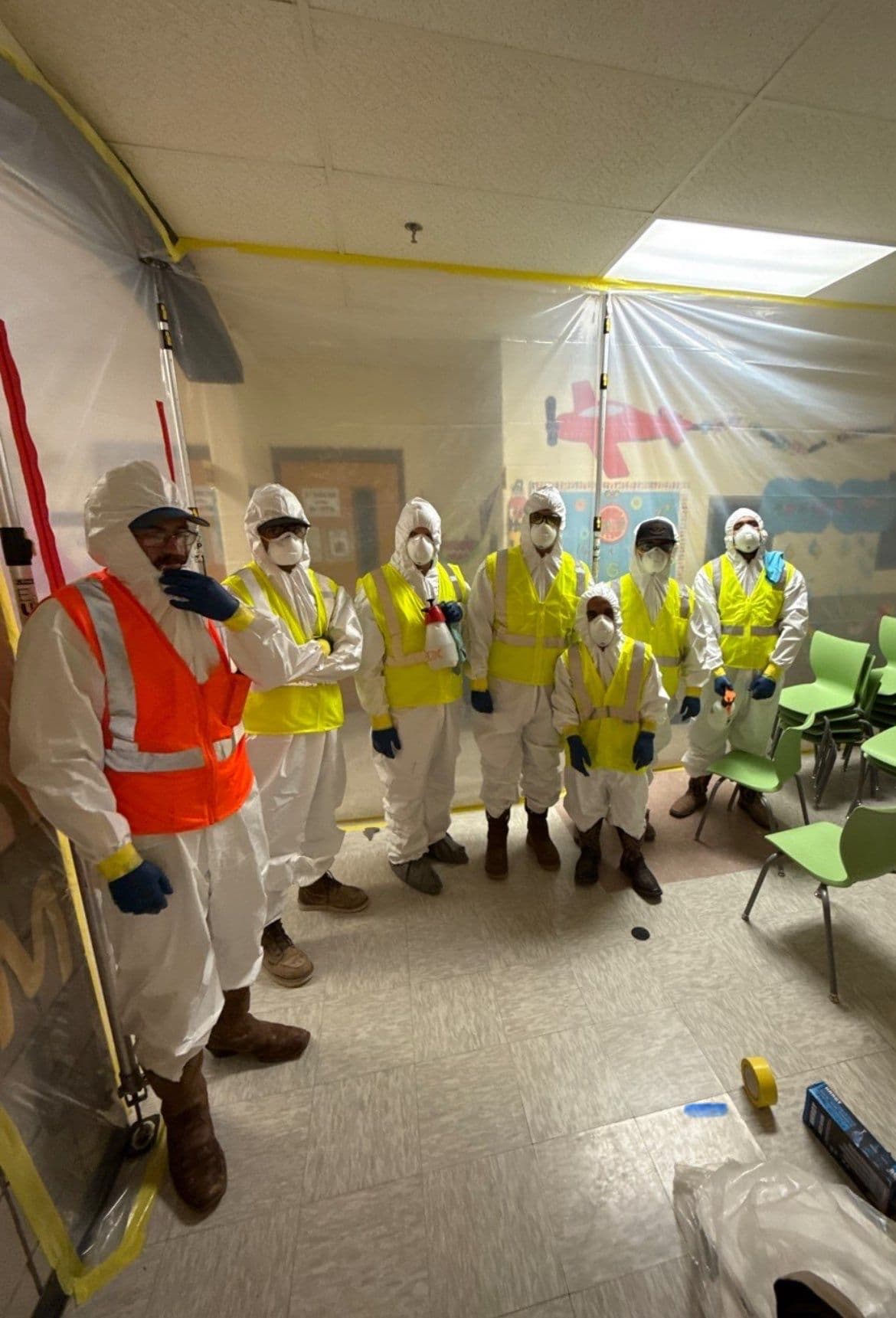 AMRT-certified mold remediation technicians in full PPE inside negative-pressure containment chamber — First Response Restoration Houston TX